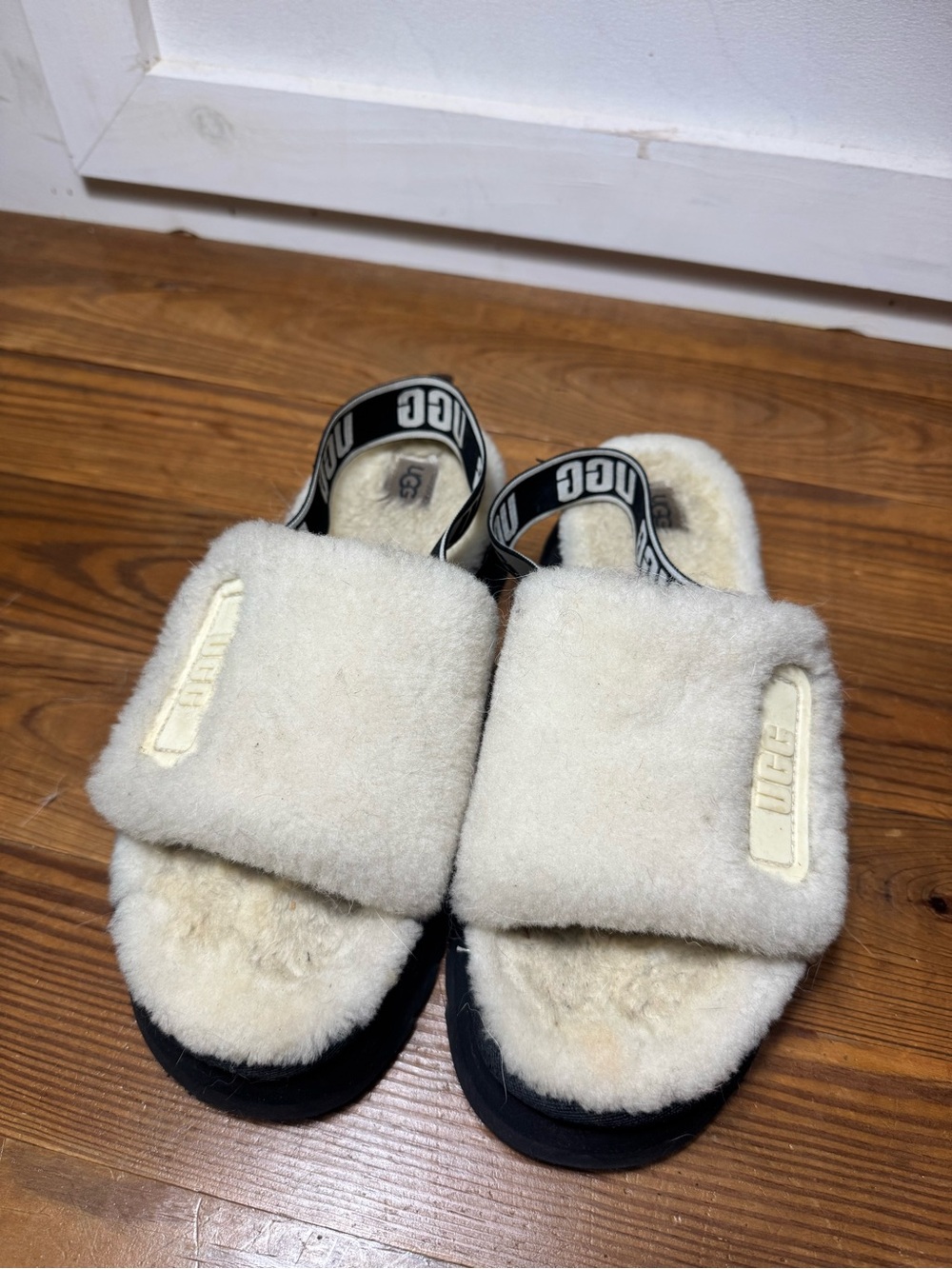 well worn UGG platform disco slide fuzzy slippers